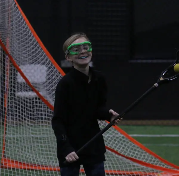 A Lakeshore Stars player stands beside the indoor goal